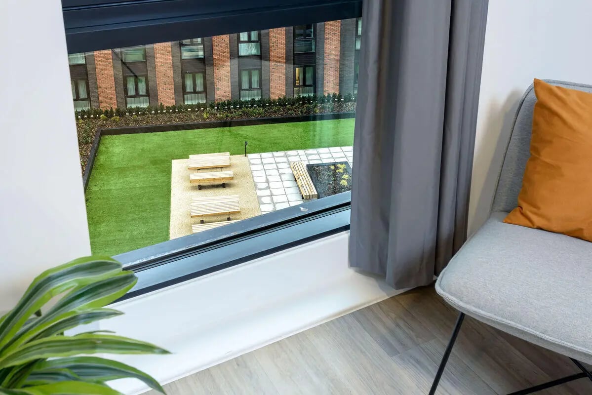 Wooden benches and seating area exterior at True Nottingham in Nottingham Student Accommodation