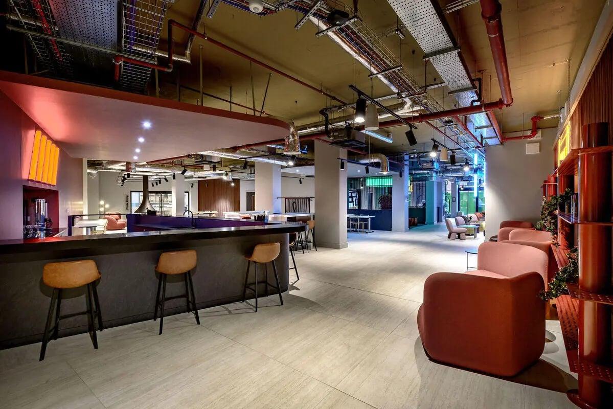 Bar with stools and lounge seating area at True Nottingham in Nottingham Student Accommodation