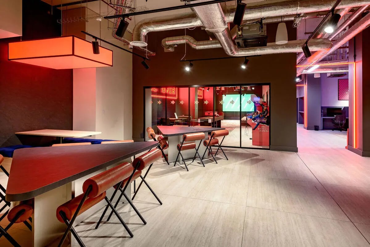Red tables and chairs student lounge area at True Nottingham in Nottingham Student Accommodation