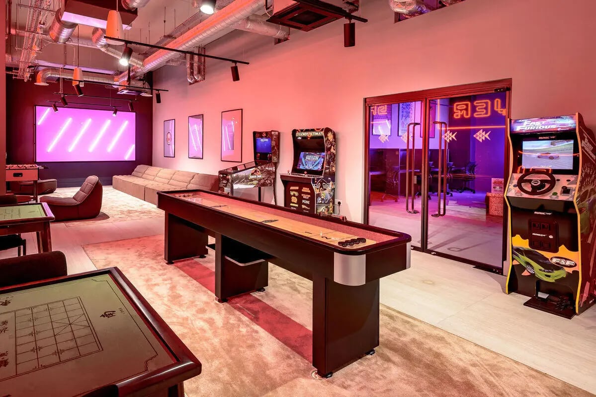 Shuffleboard arcade games couch and foosball table recreation room at True Nottingham in Nottingham Student Accommodation