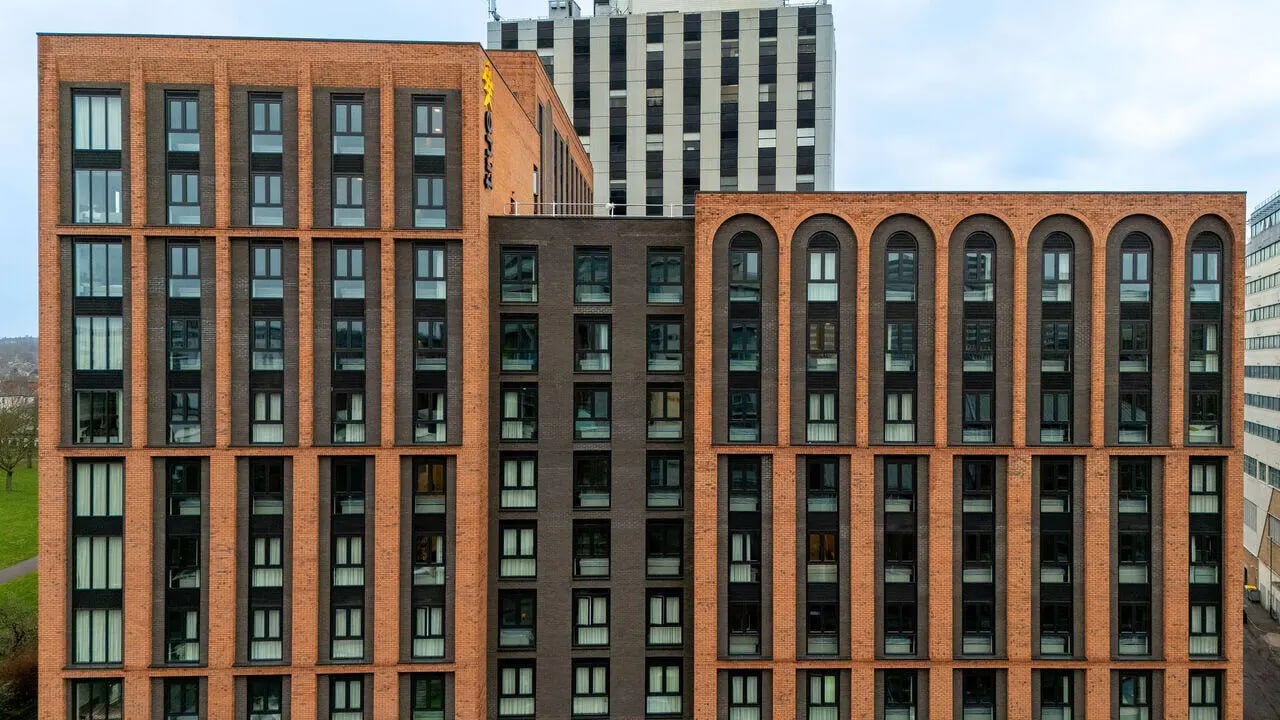 Modern brick building with many windows exterior at True Nottingham in Nottingham Student Accommodation