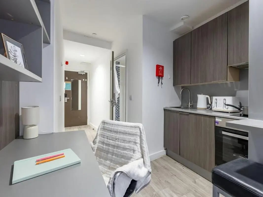 Desk chair kitchen cabinets and appliances studio apartment at Centre Gate in Bristol Student Accommodation