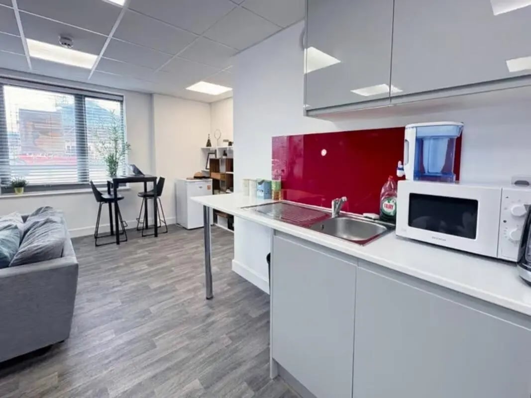 Couch table chairs microwave kitchen area at The Cube Greenwich in London Student Accommodation