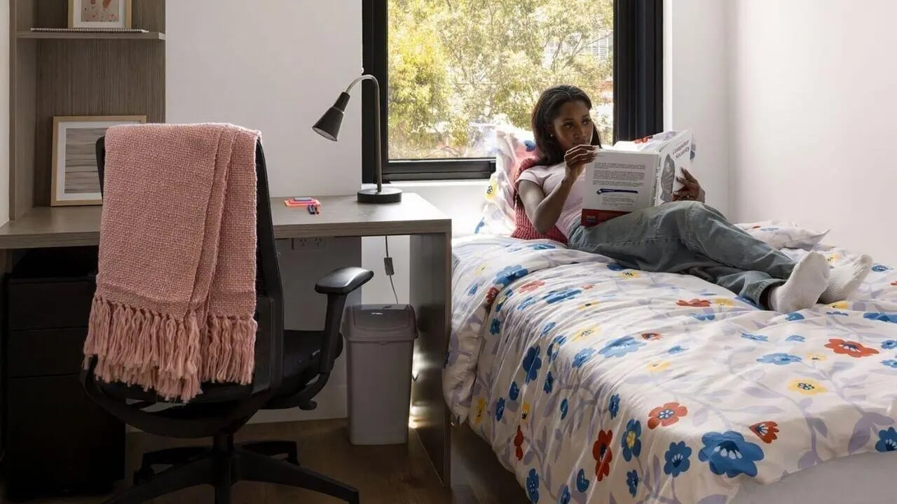 Desk bed lamp trash can and student bedroom at UniLodge Perth Central in Perth Student Accommodation