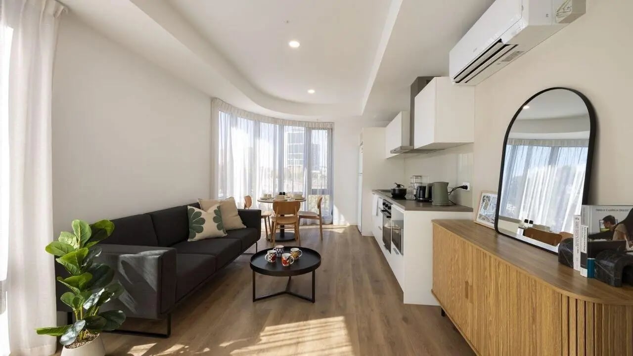 Sofa dining table kitchen and mirror living room at UniLodge Perth Central in Perth Student Accommodation