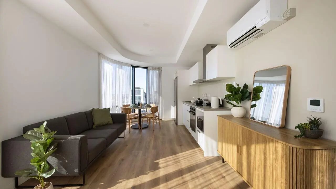 Sofa dining table kitchen with cabinets and mirror living room at UniLodge Perth Central in Perth Student Accommodation