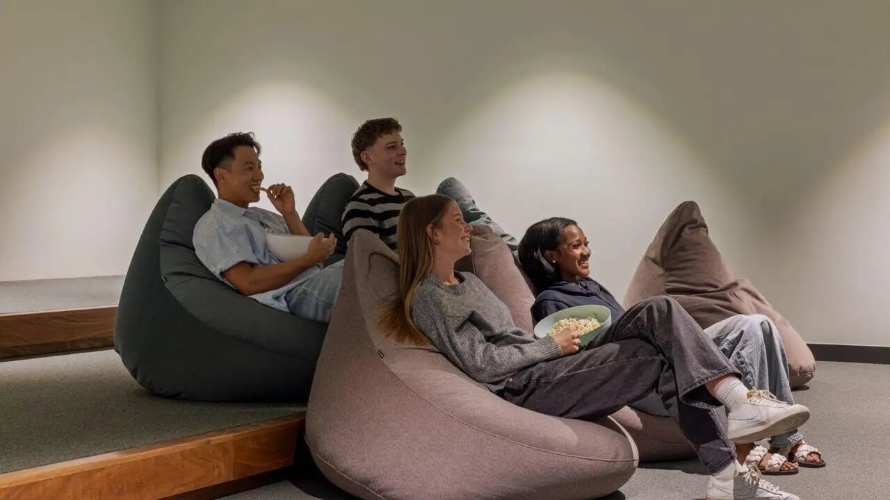 Students on beanbags eating popcorn cinema room at UniLodge Perth Central in Perth Student Accommodation