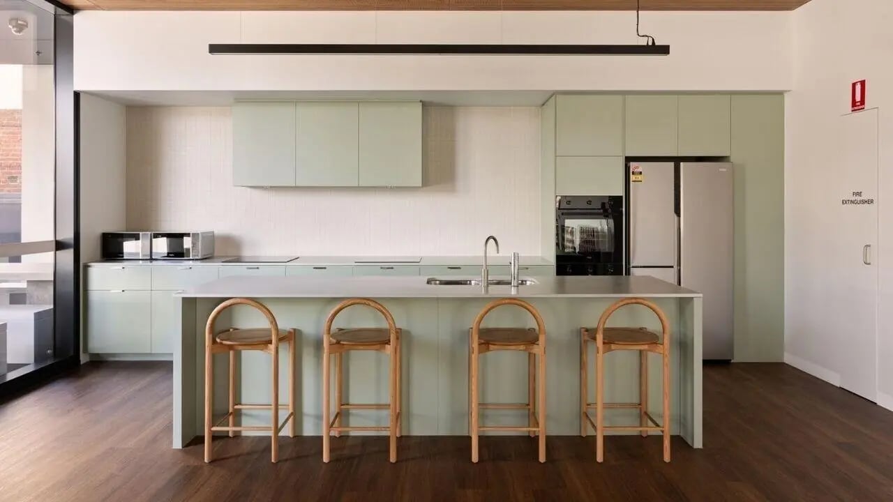 Kitchen island with bar stools and appliances kitchen at UniLodge Perth Central in Perth Student Accommodation