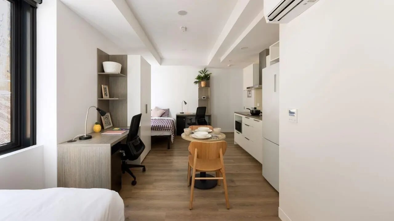 Bed desk table chairs kitchen and bedroom Studio at UniLodge Perth Central in Perth Student Accommodation