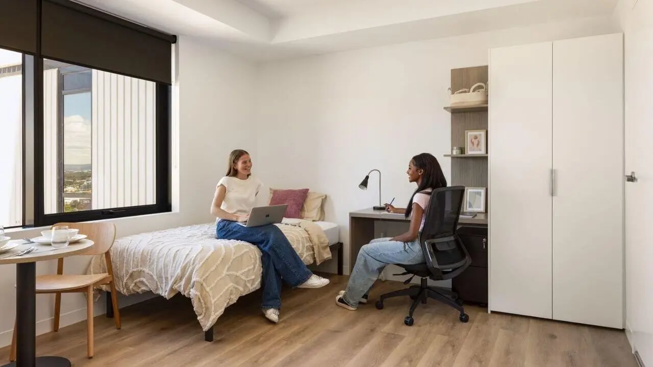 Two students study at desk and bed bedroom at UniLodge Perth Central in Perth Student Accommodation