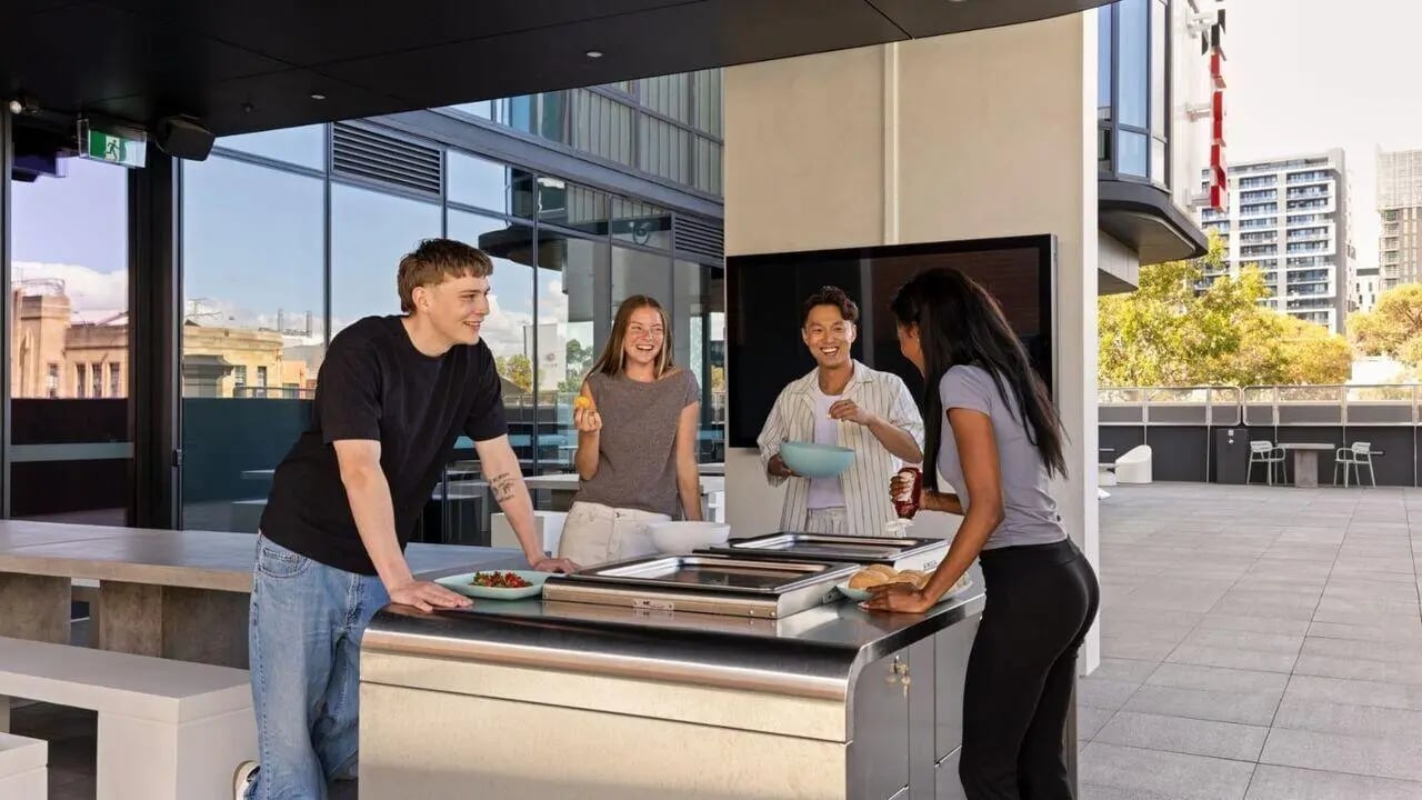 Students prepare food at outdoor kitchen living area at UniLodge Perth Central in Perth Student Accommodation