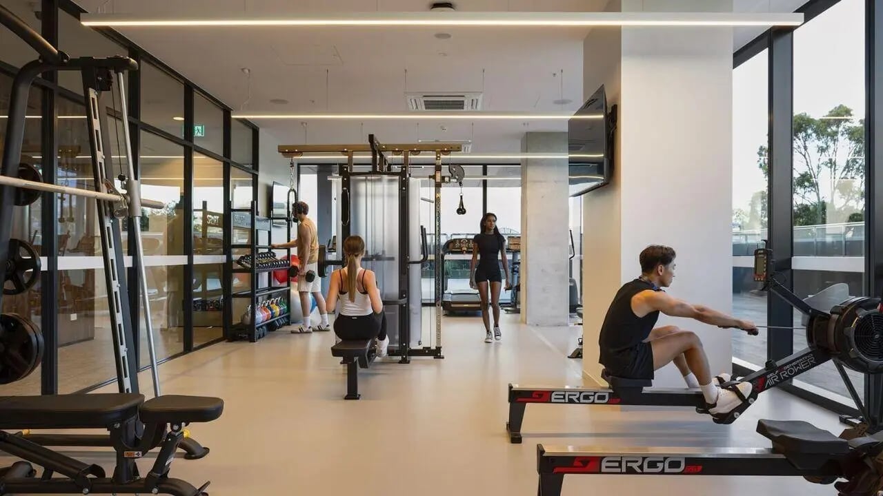 People using gym equipment exercise machines and weights gym at UniLodge Perth Central in Perth Student Accommodation