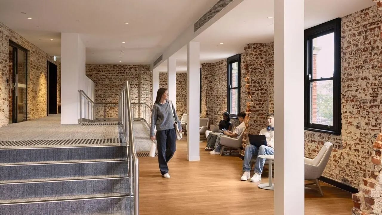 Students relax in communal area with brick walls at UniLodge Perth Central in Perth Student Accommodation