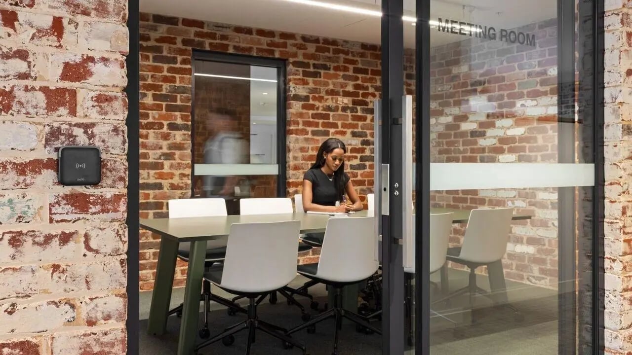 Meeting room with woman at table and chairs meeting room at UniLodge Perth Central in Perth Student Accommodation