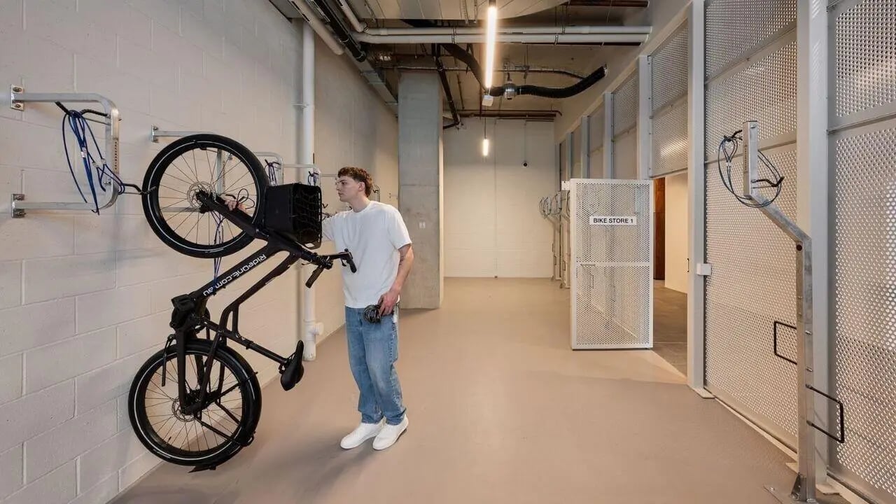 Man with bike in bike storage room. at UniLodge Perth Central in Perth Student Accommodation