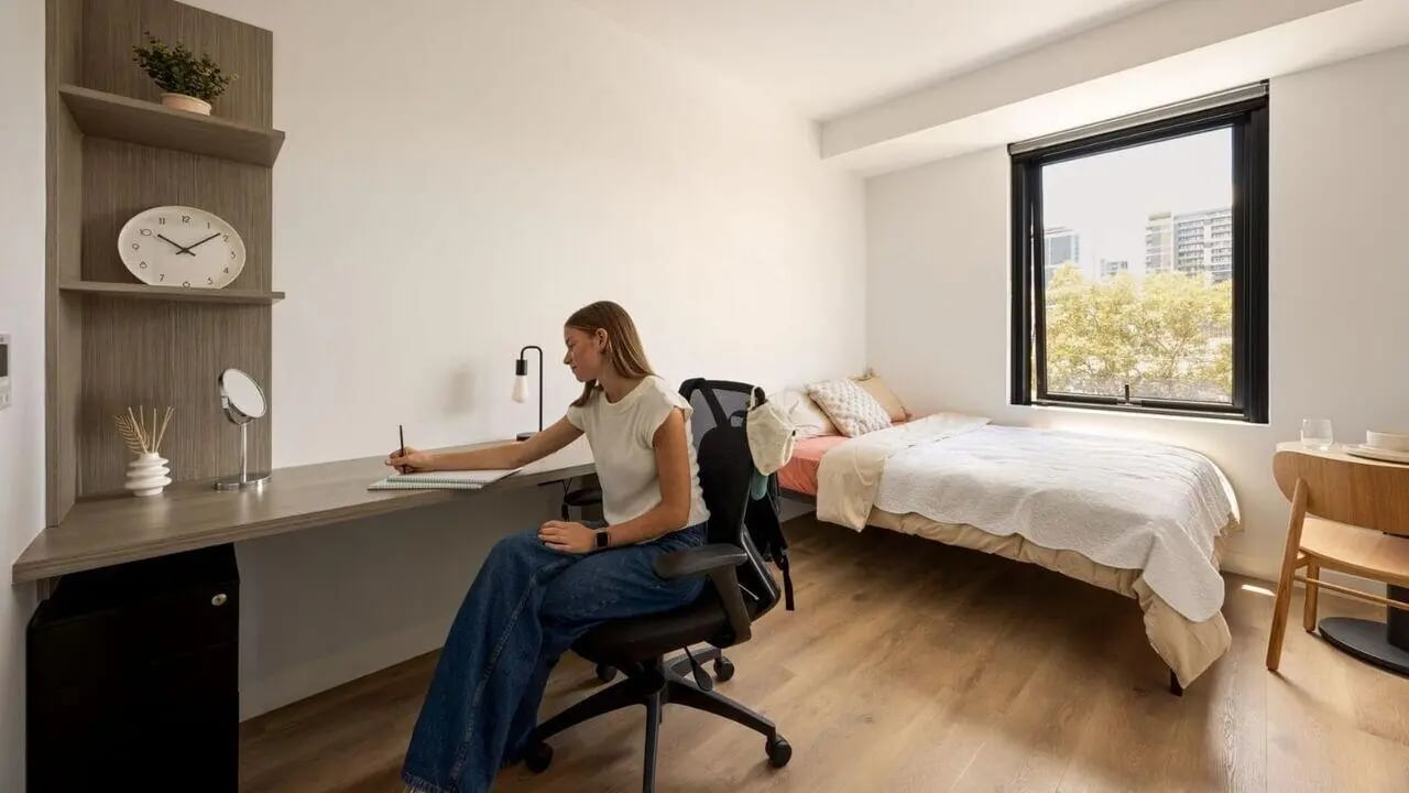 Desk bed chair and window view bedroom at UniLodge Perth Central in Perth Student Accommodation