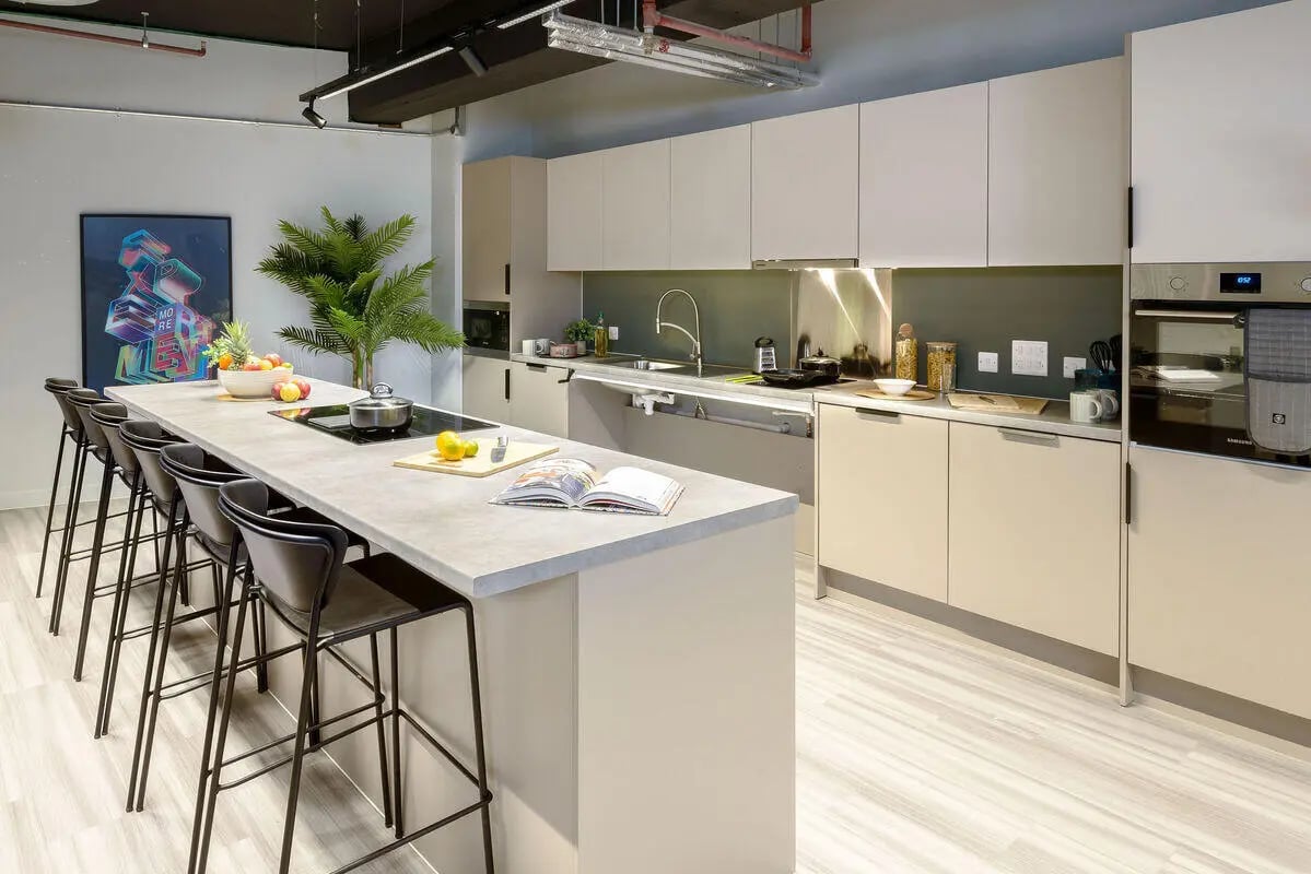 Modern kitchen with island, stools, and appliances Kitchen at True Leicester in Leicester Student Accommodation