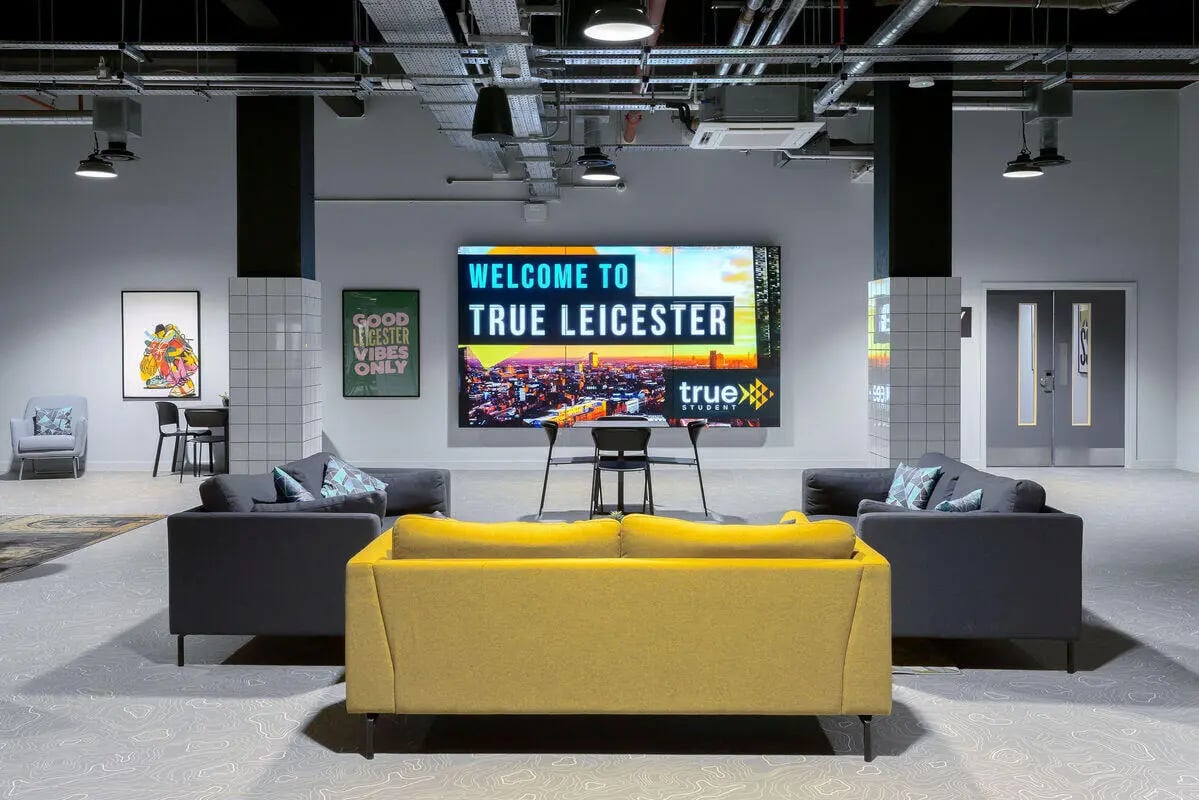 Sofas and screen welcome sign communal area at True Leicester in Leicester Student Accommodation