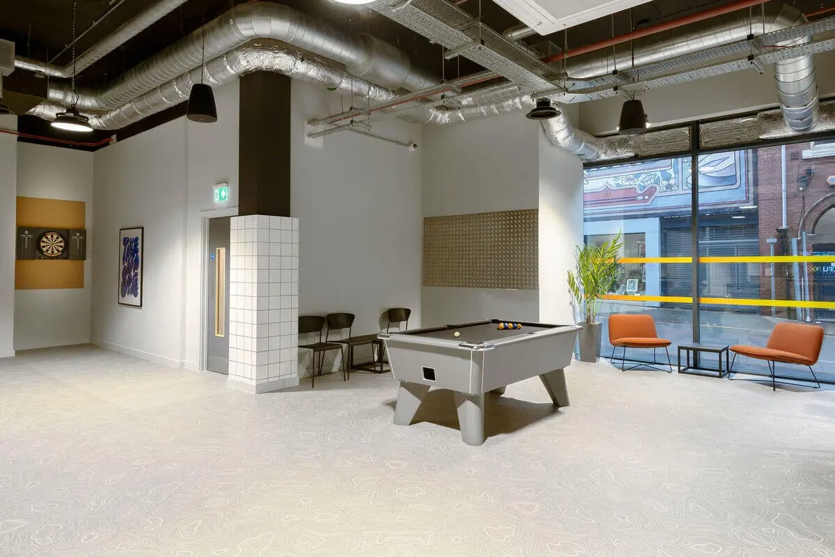 Pool table chairs dartboard and plant communal area at True Leicester in Leicester Student Accommodation