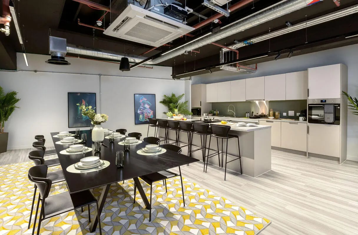 Large dining table with chairs kitchen island kitchen living area at True Leicester in Leicester Student Accommodation