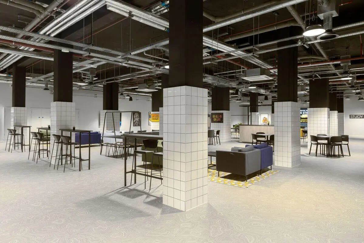 Student common area with tables sofas and chairs. at True Leicester in Leicester Student Accommodation