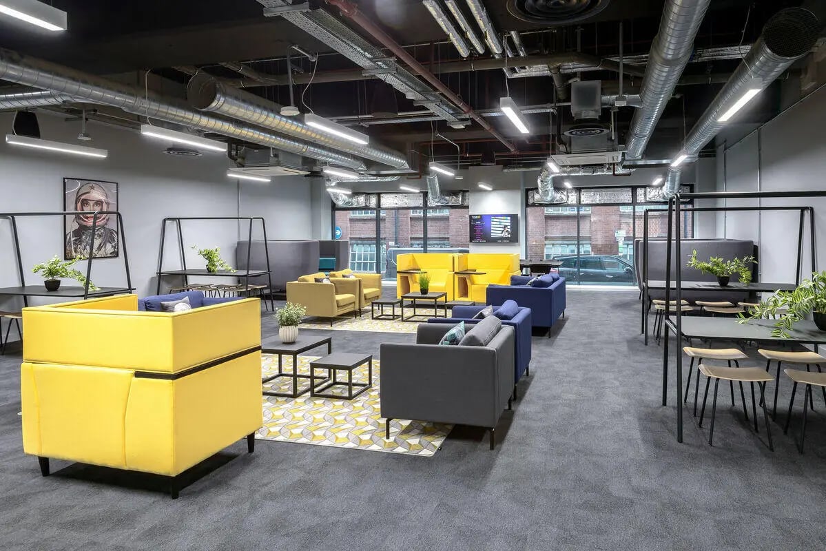 Modern lounge with yellow blue grey sofas living area at True Leicester in Leicester Student Accommodation