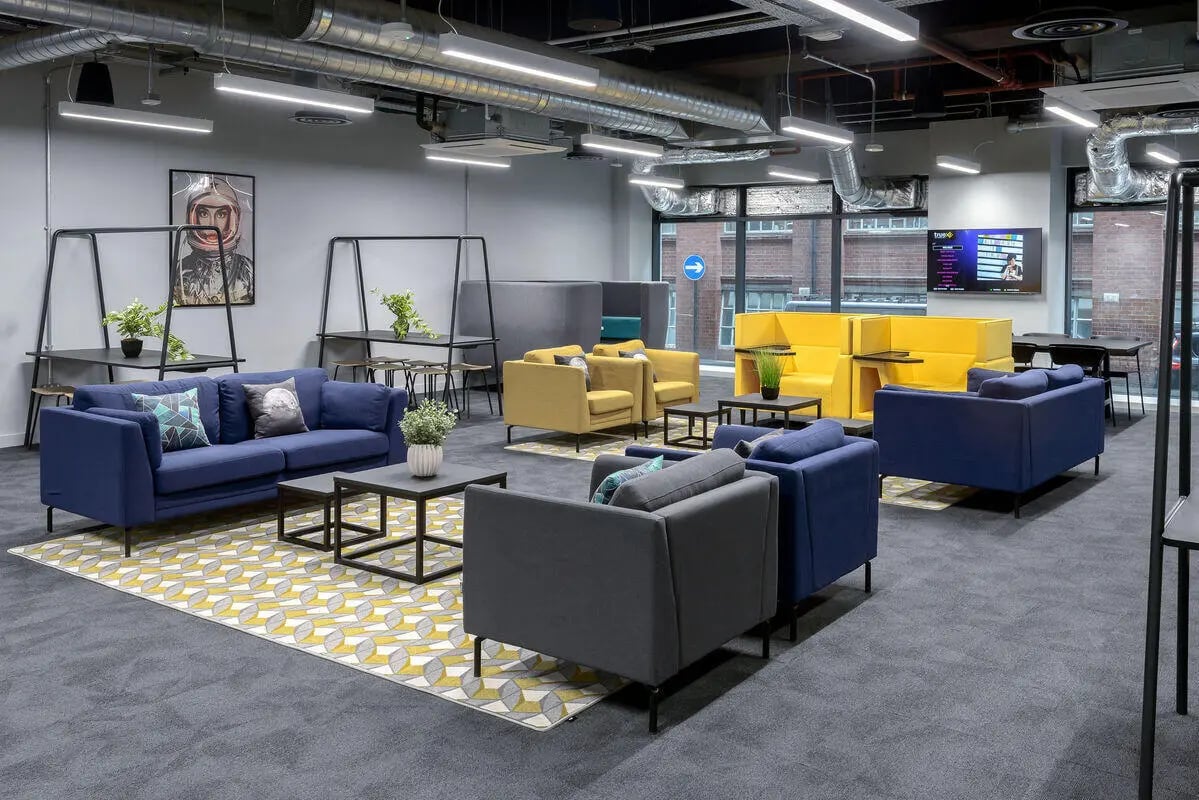 Blue sofas yellow chairs grey sofas living room at True Leicester in Leicester Student Accommodation