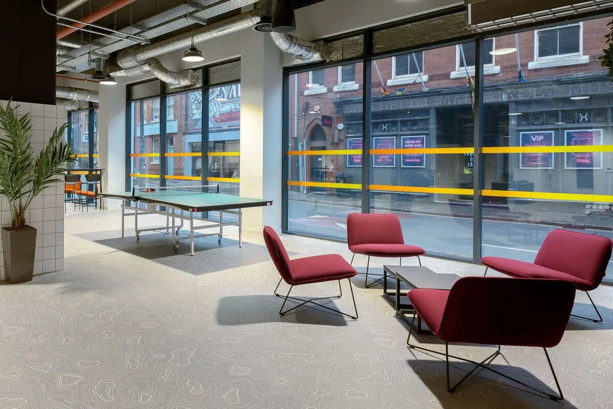 Ping pong table and red chairs common area at True Leicester in Leicester Student Accommodation