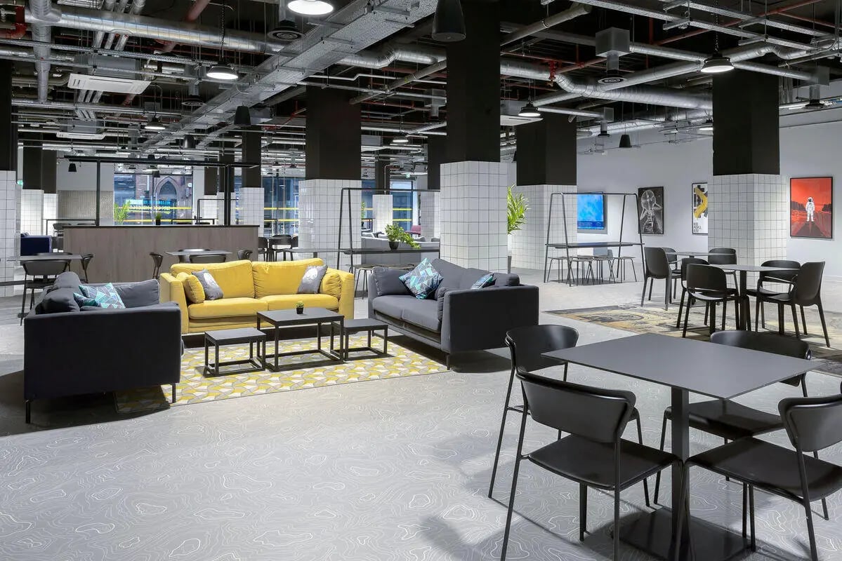 Yellow and grey sofas with coffee tables communal area at True Leicester in Leicester Student Accommodation