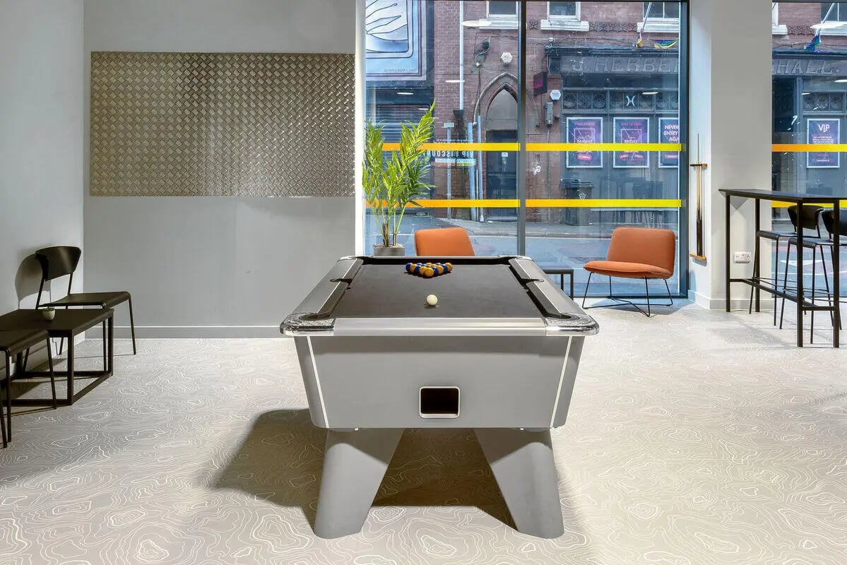 Pool table with balls chairs and bar area lounge at True Leicester in Leicester Student Accommodation