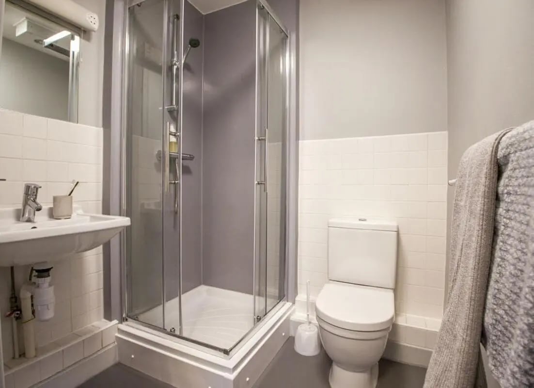 Sink shower toilet and towel bathroom at Halsmere Studios in London Student Accommodation
