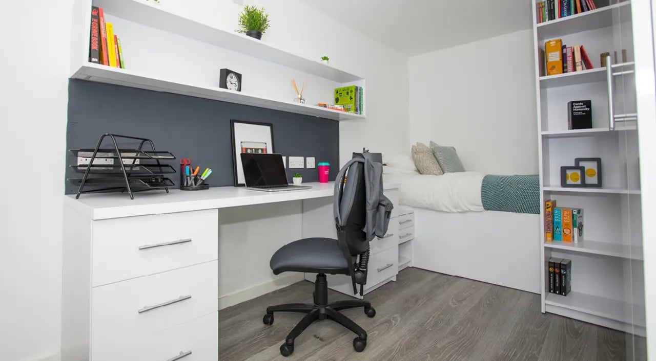 Desk chair laptop bed bookshelf bedroom study area at The Cube Ealing in London Student Accommodation