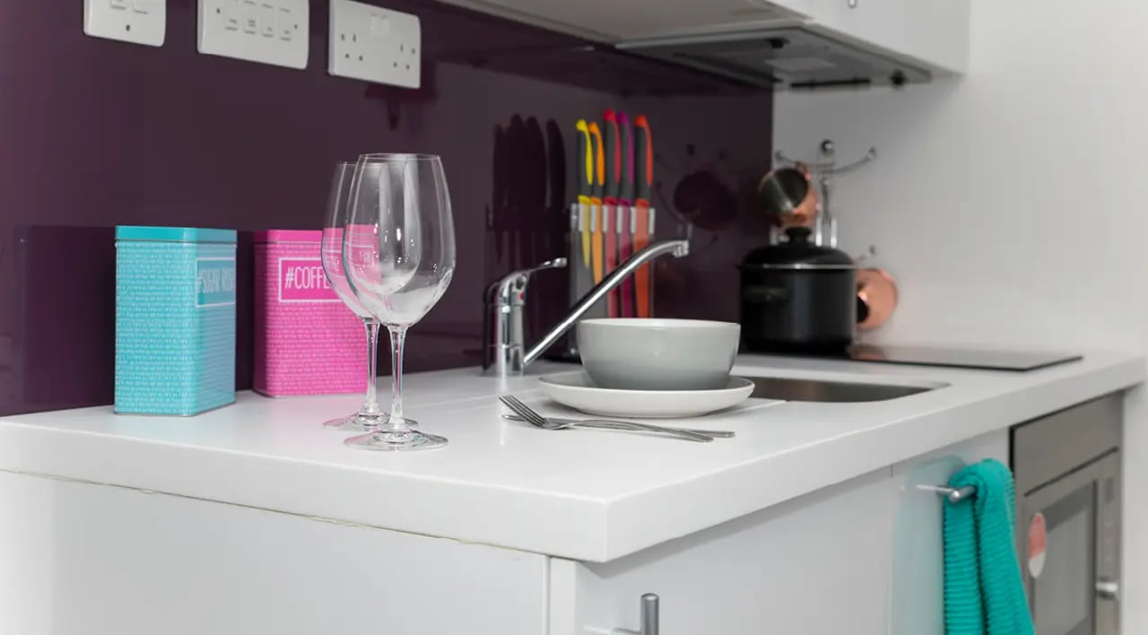 Two wine glasses two storage tins kitchen area at The Cube Ealing in London Student Accommodation