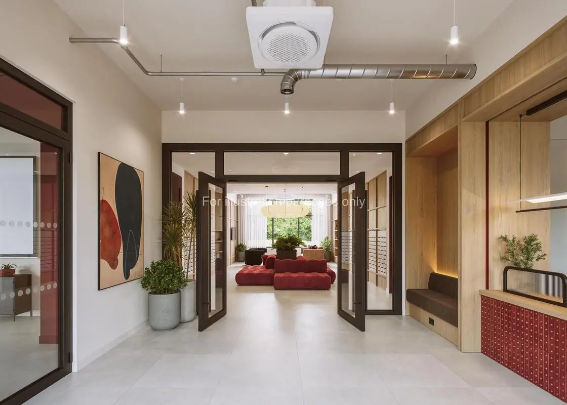 Modern communal area with red sofas and seating area Living room at Press House in London Student Accommodation