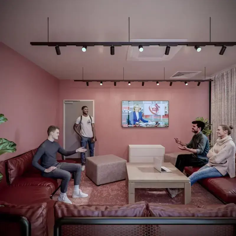 Students relaxing on sofa near TV living room at Hawthorne House in London Student Accommodation