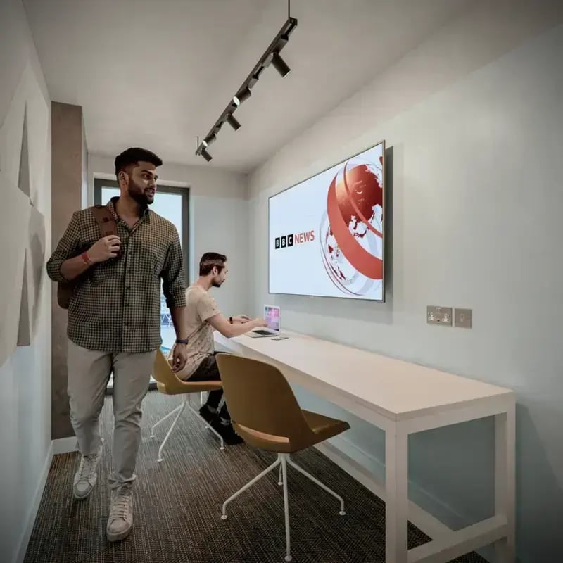 Two men and long desk with TV Study area at Hawthorne House in London Student Accommodation