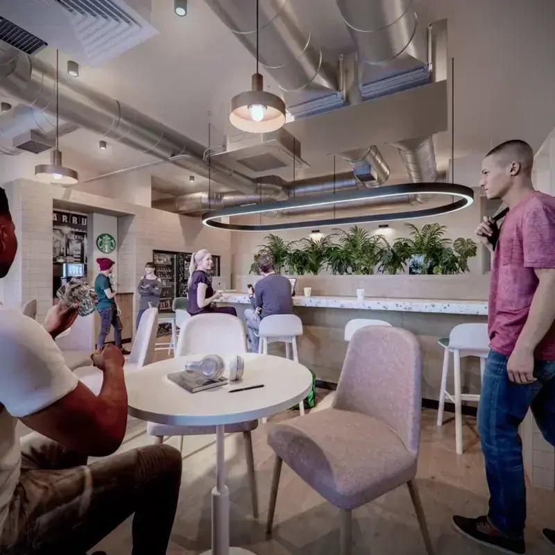 Students at cafe bar with plants shared area at Hawthorne House in London Student Accommodation