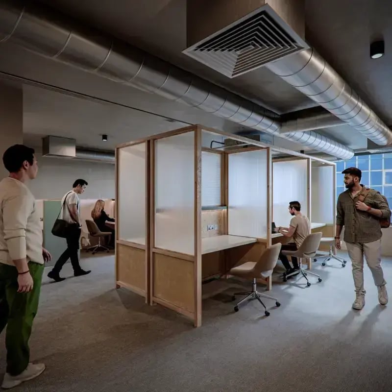 Study booths with desks and chairs common area at Hawthorne House in London Student Accommodation