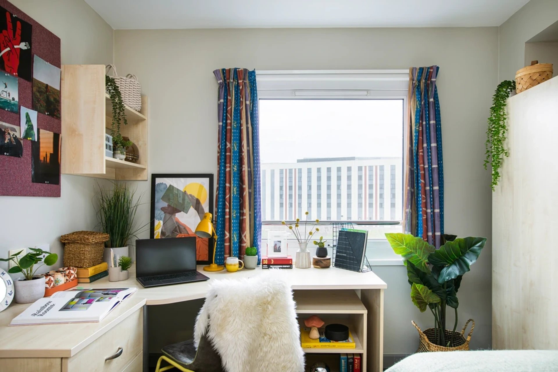 Desk with laptop plants art and chair study area at Blackfriars in Glasgow Student Accommodation
