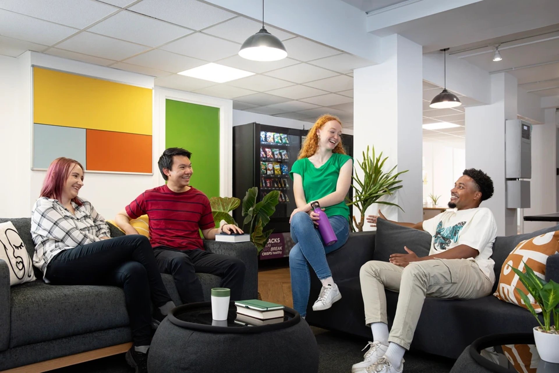 Students relaxing on sofas in common area living room at Blackfriars in Glasgow Student Accommodation