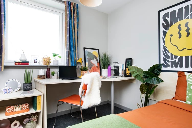 Desk with laptop plant and chair bedroom study area at Blackfriars in Glasgow Student Accommodation