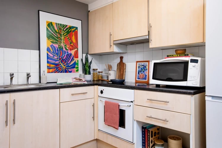 Colorful art microwave oven sink kitchen at Ewen Henderson Court in London Student Accommodation
