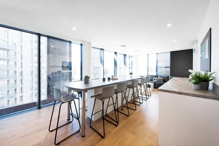 Bar stools along long counter with city view common area at Arch View House in London Student Accommodation