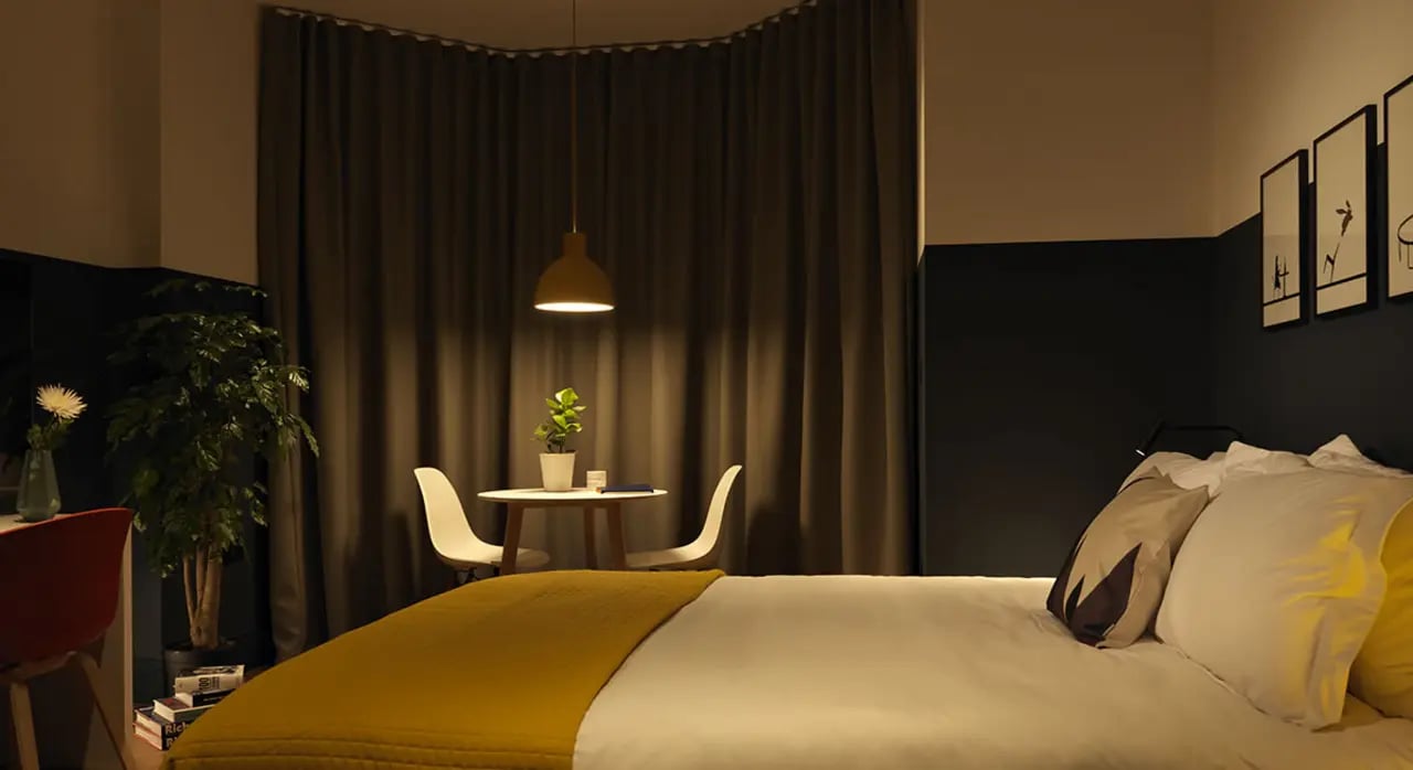 Bed with yellow throw pillows and table bedroom at Student Castle Bath in Bath Student Accommodation
