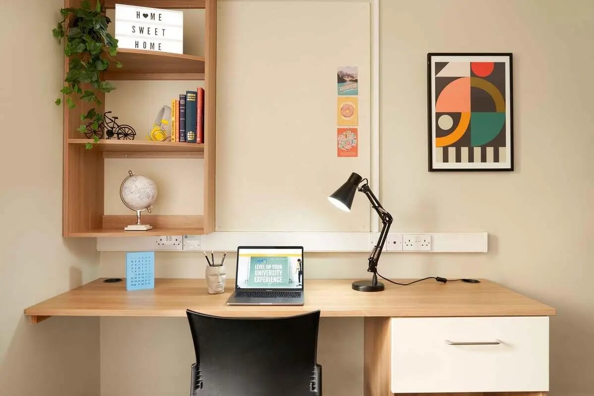 Desk with laptop lamp and shelves study area at Transom House in Bristol Student Accommodation