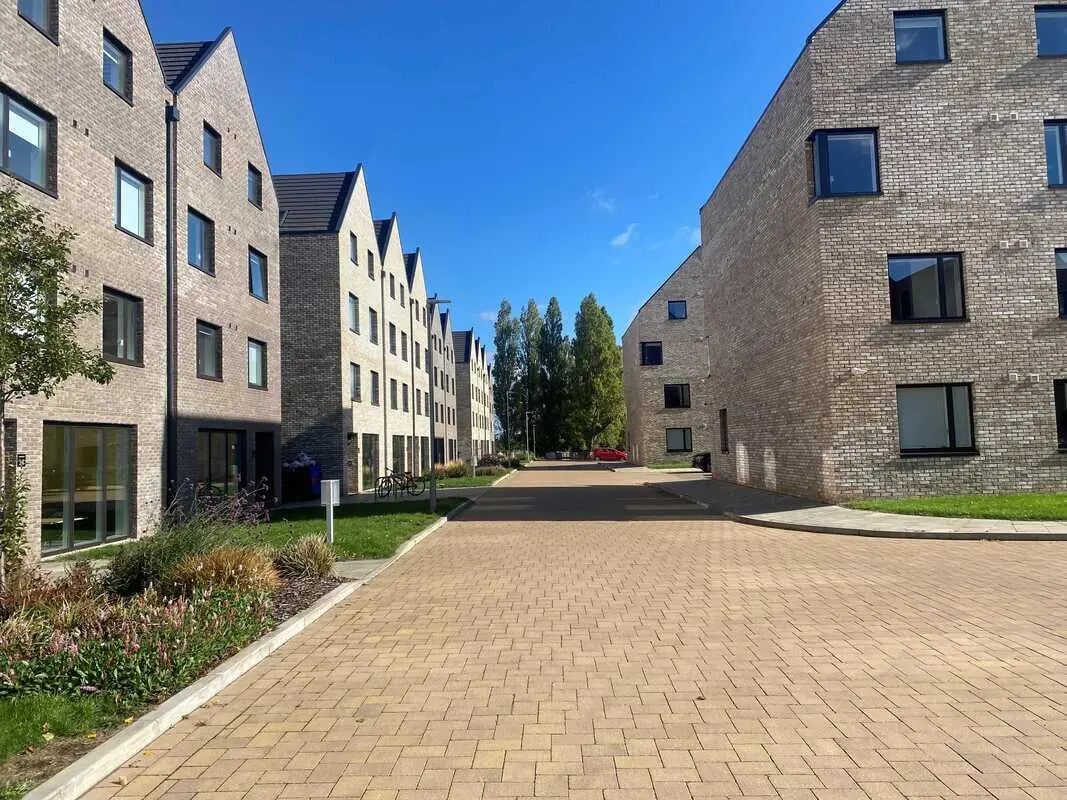 Modern brick buildings with bicycles parked outside exterior at Westwood Student Mews in Coventry Student Accommodation