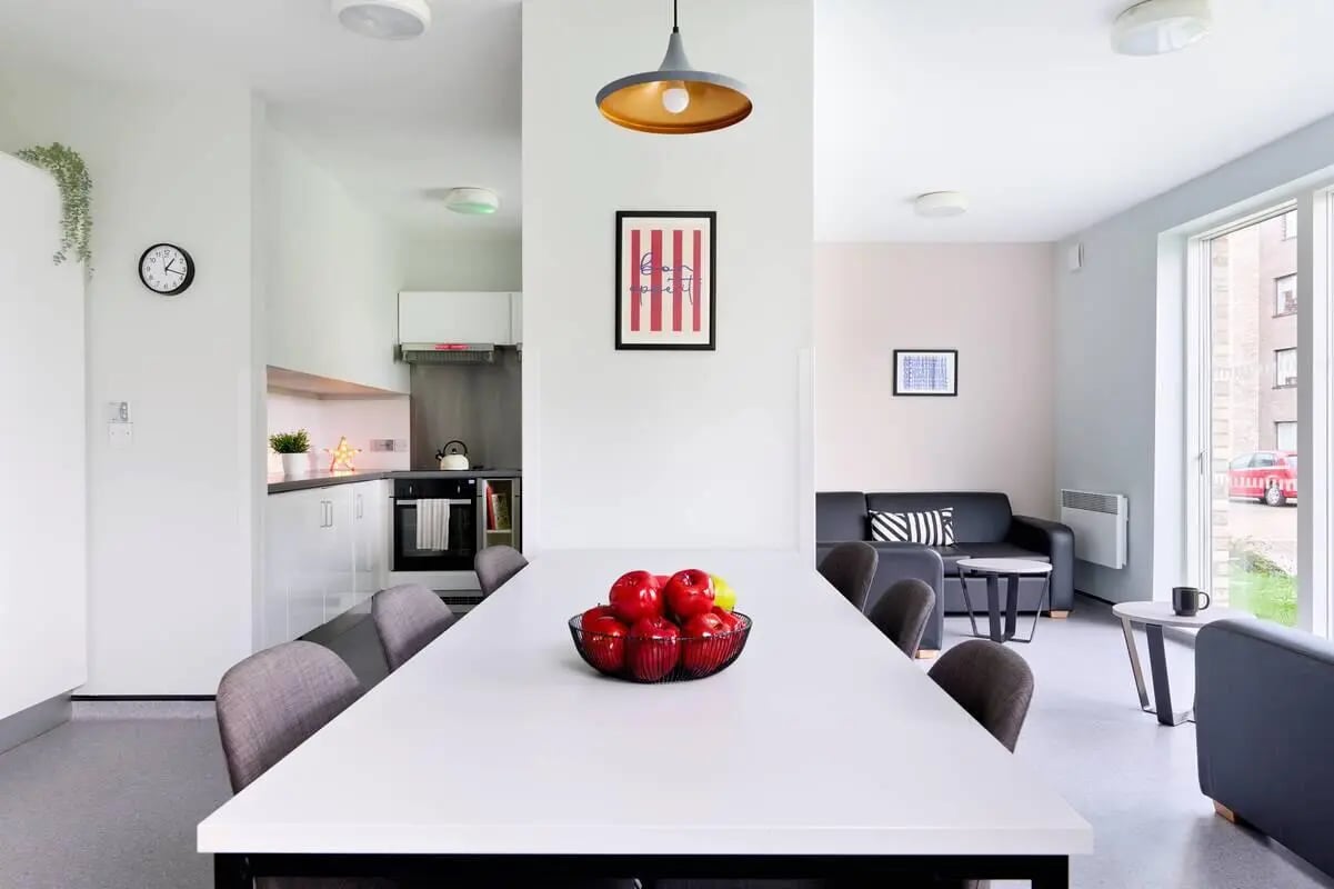 White table apples kitchen black sofa living room at Westwood Student Mews in Coventry Student Accommodation