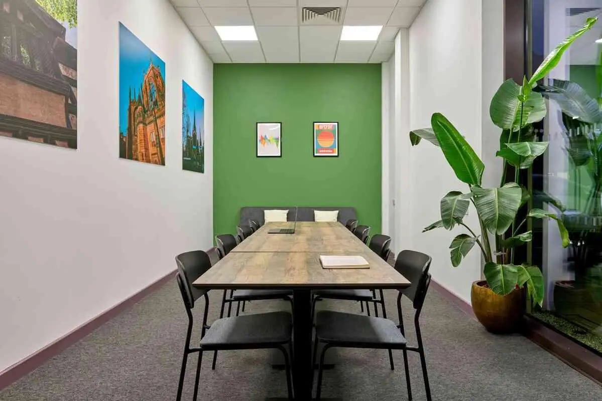 Conference table chairs laptop potted plant meeting room at Westwood Student Mews in Coventry Student Accommodation
