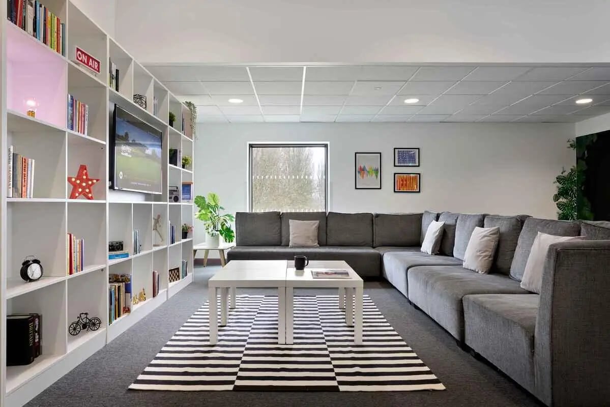 Bookshelf TV couch tables rug living room at Westwood Student Mews in Coventry Student Accommodation