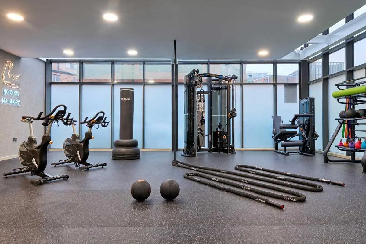 Exercise bikes punching bag cable machine gym playing area at Millennium View in Coventry Student Accommodation